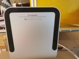an image of a white and black air purifier sitting on top of a table