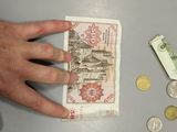 a person that is putting money in a wallet