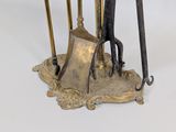 a metal stand with tools on it on a white surface