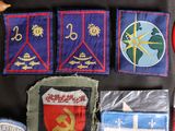 several patches and badges are laid out on a table