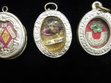 four different types of medals are displayed on a black surface