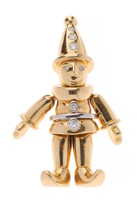 un gros plan sur une petite figurine en or sertie de diamants