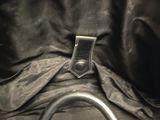 the inside of a black purse with a metal handle