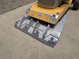 a yellow machine that is sitting on the ground