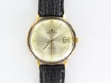 a watch that is sitting on a white surface