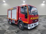 a red fire truck that is parked in a room