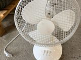 a white fan that is sitting on the ground