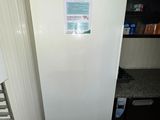 a white refrigerator that is in a kitchen next to a window
