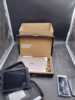 a box that has a laptop, a cell phone, and other items in it