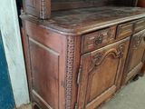 a wooden cabinet that has a shelf on top of it