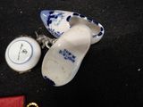 pair of blue and white shoes and a red purse on a black surface