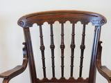 a wooden chair that has a wooden seat on it
