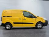 the yellow van is parked in a large room with a white wall