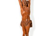 an image of a wooden statue of jesus hanging on a wall