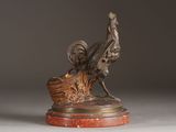 statue of a rooster on a marble base on a gray background