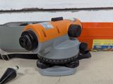 an orange and black object sitting on top of a table next to a tool