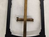 a cross on a white plate with a gold cross on it