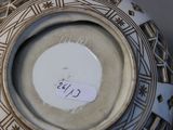 a close up of a vase with a tag on it