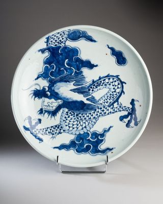 blue and white porcelain plate with a dragon on it