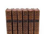 a set of five old books sitting on top of each other