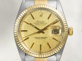 une photo d'une montre Rolex en or et argent avec un cadran jaune