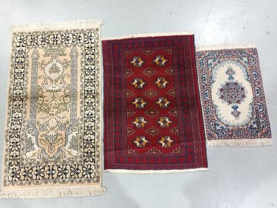 three oriental rugs on a white surface