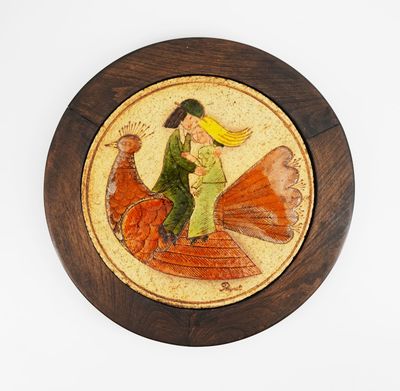 a wooden plate with a picture of a woman riding a bird