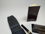 leather wallet with pen and business card next to it on a table