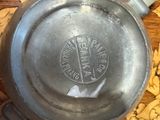 an old frying pan sitting on a table with corks