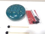 a blue drum and two matches on a white table
