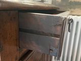 a wooden cabinet with a drawer on top of it