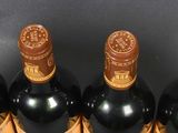 several bottles of wine are lined up in a row on a table