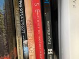 many books that are on a shelf in the room