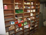 many shelves with various items on them in a room
