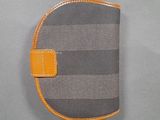 a close up of a gray and orange wallet on a gray surface