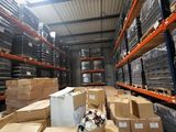 many boxes in a large warehouse with a lot of shelves