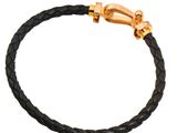 a black leather bracelet with a gold clasp