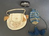 two purses and a cell phone on a table