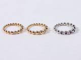 three gold and silver rings on a white background