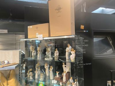 many figurines on display in a glass case