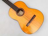 a guitar that is sitting on a white surface