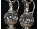 une paire de vases anciens en verre plaqué argent, posés sur des socles