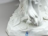 a statue of a woman holding a bird in her hand