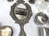 a lot of silver objects on a table with a white table cloth