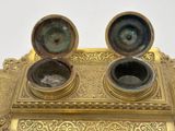 a gold colored box with two bowls on top of it
