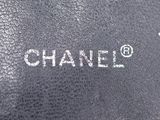 a close up of a black bag with the word chanel written on it