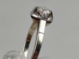 a close up of a ring with a diamond on it