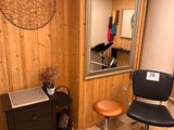 a desk with a chair and a mirror in a room