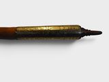a pen with writing on it sitting on a white surface