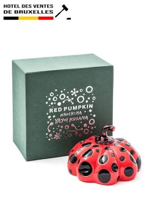 perfume bottle in the shape of a ladybug in front of a box